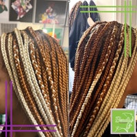 a woman's hair is braided with different colors